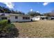 Spacious backyard featuring an open lawn and an adjacent light colored home exterior at 9691 Sw 95Th Ct # A, Ocala, FL 34481