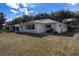 Home's backyard with a patio, view of the house, and lawn at 9691 Sw 95Th Ct # A, Ocala, FL 34481