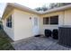 Backyard patio area with exterior door, air conditioning unit, and space to relax at 9691 Sw 95Th Ct # A, Ocala, FL 34481