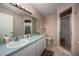 Bright bathroom features a large mirror, white cabinets, and glass-enclosed shower at 9691 Sw 95Th Ct # A, Ocala, FL 34481