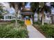 Club entrance with a gold dome roof, yellow steps, and surrounded by landscaped greenery at 9691 Sw 95Th Ct # A, Ocala, FL 34481