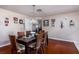 A light dining room featuring a dark wood table with seating for six and a collection of wall art at 9691 Sw 95Th Ct # A, Ocala, FL 34481