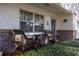 Charming front porch with wicker chairs, brick accents, and a welcoming entryway at 9691 Sw 95Th Ct # A, Ocala, FL 34481