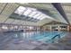 Bright indoor swimming pool featuring lap lanes and a translucent roof for natural light at 9691 Sw 95Th Ct # A, Ocala, FL 34481