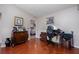 Inviting home office featuring a hardwood floor and classic furnishings and an adjacent bedroom at 9691 Sw 95Th Ct # A, Ocala, FL 34481