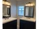 Modern bathroom with double sink vanities and updated light fixtures at 16862 Se 80 Bellavista Cir, The Villages, FL 32162