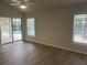 Bright bedroom with wood floors and sliding glass doors to the pool area at 16862 Se 80 Bellavista Cir, The Villages, FL 32162