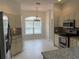 Traditional kitchen with granite countertops, stainless appliances, and tile floors at 16862 Se 80 Bellavista Cir, The Villages, FL 32162
