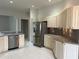 Bright kitchen featuring stainless steel appliances and sleek countertops, ready for culinary adventures at 16862 Se 80 Bellavista Cir, The Villages, FL 32162