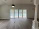 Living room showcasing vaulted ceiling, ceiling fan, and sliding glass doors to the pool at 16862 Se 80 Bellavista Cir, The Villages, FL 32162