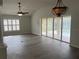 Spacious living room features a ceiling fan, wood floors, and sliding glass doors to the pool at 16862 Se 80 Bellavista Cir, The Villages, FL 32162