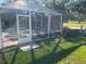 A screened-in pool area adjoins a well-manicured green, offering a relaxing, private outdoor experience at 16862 Se 80 Bellavista Cir, The Villages, FL 32162