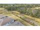 A view of a walking path running behind a row of houses in a community with mature trees at 5341 Nw 48Th Pl, Ocala, FL 34482