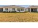 Large backyard featuring the back exterior of the home and an enclosed sunroom at 5341 Nw 48Th Pl, Ocala, FL 34482
