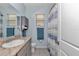Cozy bathroom featuring granite countertop, modern sink, and decorative shower curtain at 5341 Nw 48Th Pl, Ocala, FL 34482