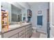 Well-lit bathroom featuring double sinks, granite countertops, and a walk-in shower at 5341 Nw 48Th Pl, Ocala, FL 34482