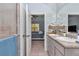 Ensuite bathroom featuring double sinks and a view into the main bedroom at 5341 Nw 48Th Pl, Ocala, FL 34482