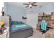 Well-lit bedroom with a gray bed frame, desk, and ample shelving for display at 5341 Nw 48Th Pl, Ocala, FL 34482