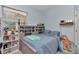 Cozy bedroom featuring a gray bed, a plush blanket, and a window with natural light at 5341 Nw 48Th Pl, Ocala, FL 34482