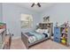 Comfortable bedroom with a twin bed, grey furnishings, ceiling fan, and plenty of storage at 5341 Nw 48Th Pl, Ocala, FL 34482