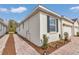 Side view of a white home with brick pathway and manicured landscaping at 5341 Nw 48Th Pl, Ocala, FL 34482