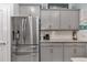 Modern kitchen with stainless steel refrigerator, ample cabinets, and granite countertops at 5341 Nw 48Th Pl, Ocala, FL 34482