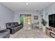 Living room showcasing glass doors, tile flooring, and a comfortable seating area at 5341 Nw 48Th Pl, Ocala, FL 34482