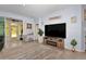 Bright living room featuring tile floors, a large screen tv, and glass doors leading to an outdoor space at 5341 Nw 48Th Pl, Ocala, FL 34482