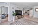Open-concept living room with tile floors, entertainment center with electric fireplace, and view into the kitchen at 5341 Nw 48Th Pl, Ocala, FL 34482