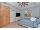Relax in this main bedroom with a private wardrobe, window, and a ceiling fan at 5341 Nw 48Th Pl, Ocala, FL 34482