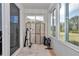 Bright sun room featuring a decorative privacy screen, fitness equipment, and backyard views at 5341 Nw 48Th Pl, Ocala, FL 34482