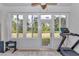 Bright sun room with large windows offering a backyard view, perfect for a home gym at 5341 Nw 48Th Pl, Ocala, FL 34482
