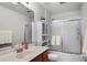 Clean bathroom featuring dual shower/tub, a vanity with wood cabinets, and decorative shelving at 2251 Oakington St, Winter Garden, FL 34787