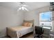 Bright bedroom featuring tile floors, a ceiling fan, and a desk area by the window offering natural light at 2251 Oakington St, Winter Garden, FL 34787