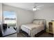 Cozy bedroom with a metal frame bed, a ceiling fan, and a bright window overlooking a water view at 2251 Oakington St, Winter Garden, FL 34787