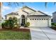 Charming one-story home featuring a well-manicured lawn and a two-car garage at 2251 Oakington St, Winter Garden, FL 34787