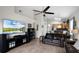 Spacious living room featuring wood-look tile, a ceiling fan, and ample seating at 2251 Oakington St, Winter Garden, FL 34787