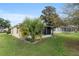 Exterior view of the home's backyard with the screened porch, landscaping, and well maintained lawn at 9481 Sw 93Rd Loop, Ocala, FL 34481