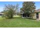 Backyard view of the home's landscaping, mature trees, and screened-in porch at 9481 Sw 93Rd Loop, Ocala, FL 34481