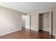 Well-lit bedroom with closet, wood style flooring, and fresh paint at 9481 Sw 93Rd Loop, Ocala, FL 34481