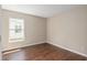 Empty bedroom featuring wood-style floors and natural light from the window at 9481 Sw 93Rd Loop, Ocala, FL 34481