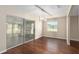 Dining area features hardwood floors, a modern chandelier, and sliding glass doors at 9481 Sw 93Rd Loop, Ocala, FL 34481