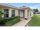 Inviting home exterior showcasing large windows and a bright, welcoming front door entrance at 9481 Sw 93Rd Loop, Ocala, FL 34481