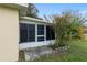 View of the home's screened-in porch exterior with a well maintained lawn and landscaping at 9481 Sw 93Rd Loop, Ocala, FL 34481