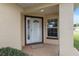 Charming front porch featuring a white front door with decorative glass and a cozy entryway at 9481 Sw 93Rd Loop, Ocala, FL 34481