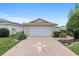 Spacious two-car garage with a long driveway featuring unique compass design at 9481 Sw 93Rd Loop, Ocala, FL 34481