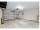 Spacious garage with a roll up door, ceiling lighting, and concrete floor at 9481 Sw 93Rd Loop, Ocala, FL 34481