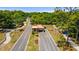 Aerial shot of the community entrance gate with lush landscaping and winding roads at 9481 Sw 93Rd Loop, Ocala, FL 34481