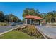 Community entrance gate with holiday decorations and colorful flowerbeds at 9481 Sw 93Rd Loop, Ocala, FL 34481