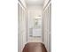 Hallway leading to a bathroom with closet and laminate flooring at 9481 Sw 93Rd Loop, Ocala, FL 34481